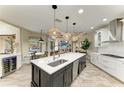 Beautiful kitchen featuring a large island, modern appliances, and an open view to the living and dining areas at 6674 Coopers Hawk Ct, Lakewood Ranch, FL 34202