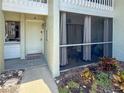 Inviting condo entrance featuring a screened porch and charming landscaping with a garden at 6713 Midnight Pass Rd # 4, Sarasota, FL 34242