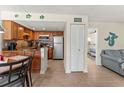 A beautifully maintained kitchen boasts stainless steel appliances and warm wood cabinets at 6713 Midnight Pass Rd # 4, Sarasota, FL 34242