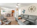 Cozy living room with bright walls and an open layout to the kitchen and direct access to porch at 6713 Midnight Pass Rd # 4, Sarasota, FL 34242