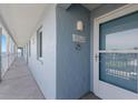 Condo entrance on walkway to beach featuring unit number and beach access at 7000 Gulf Dr # 205, Holmes Beach, FL 34217