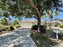 Well-maintained single-story home with a two-car garage and mature trees at 7330 Kensington Ct, University Park, FL 34201