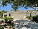 Charming single-story home with a two-car garage and well-maintained lawn at 7330 Kensington Ct, University Park, FL 34201