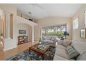 Bright living room with vaulted ceiling and large window overlooking the backyard at 7821 Troon Ct, Lakewood Ranch, FL 34202