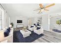Inviting living room with modern furniture and a TV, perfect for relaxation at 920 Myrtle Ave, Venice, FL 34285