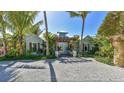 Charming coastal home with a trellis entry, tropical landscaping, and a serene beach vibe at 102 & 104 48Th St, Holmes Beach, FL 34217
