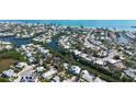 Stunning aerial view of a waterfront neighborhood with lush greenery and canal access at 120 Hammock Rd, Anna Maria, FL 34216