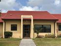 Inviting entrance to a villa with a red tile roof and neatly trimmed greenery at 1214 56Th W St # 1214, Bradenton, FL 34209