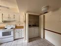Functional kitchen space featuring white cabinets, appliances, and convenient in-closet laundry setup at 1214 56Th W St # 1214, Bradenton, FL 34209