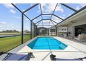 Screened-in pool with outdoor seating, perfect for relaxation and entertaining with lake views in the backyard at 12339 Glenridge Ln, Parrish, FL 34219