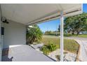 Covered front porch with view of a landscaped yard and neighboring body of water at 1234 29Th St N, St Petersburg, FL 33713