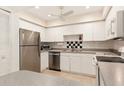 Contemporary kitchen featuring stainless steel appliances and ample white cabinets at 1629 Pelican Cove Rd # 138A, Sarasota, FL 34231