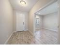 Bright foyer featuring tile floors, white front door, and an adjacent office space at 1739 Lake Verona Cir, Bradenton, FL 34211