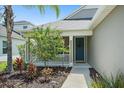 Inviting home exterior with a charming front porch and lush landscaping at 1739 Lake Verona Cir, Bradenton, FL 34211