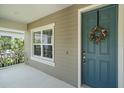 Charming front door with wreath and sidelight window, complemented by a cozy porch at 1739 Lake Verona Cir, Bradenton, FL 34211