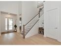 Bright foyer with wood flooring, staircase, and high ceilings at 17904 Palmiste Dr, Bradenton, FL 34202