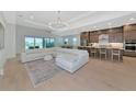 Open-concept living room and kitchen featuring lots of seating, natural light, and modern fixtures at 17904 Palmiste Dr, Bradenton, FL 34202