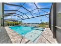 Stunning screened-in pool area with a beautiful lake view, perfect for outdoor relaxation and entertainment at 17904 Palmiste Dr, Bradenton, FL 34202