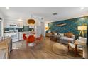Open-concept living space with stylish decor, a fish accent wall, and a seamless flow into the modern kitchen at 205 71St St # B, Holmes Beach, FL 34217
