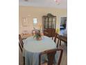 Cozy dining room area with seating for four around an oval table, and a china cabinet at 24028 Park Place S Dr # 32, Punta Gorda, FL 33980