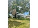 Beautiful two-story home with a well-manicured lawn and mature landscaping at 2494 S Milmar Dr, Sarasota, FL 34237