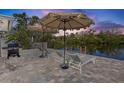 Enjoy canal views in the shade from your patio with lounge seating and a grill at 306 68Th St, Holmes Beach, FL 34217