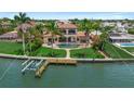Waterfront home featuring lush landscaping, swimming pool, private dock, and stunning curb appeal at 3576 San Remo Ter, Sarasota, FL 34239