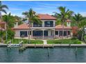 Waterfront home with lush landscaping, swimming pool, outdoor seating and private boat dock at 3576 San Remo Ter, Sarasota, FL 34239