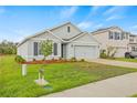 A beautiful gray single-story home features a two-car garage, lovely landscaping, and a well-maintained lawn at 3834 Silver Strand Trl, Palmetto, FL 34221