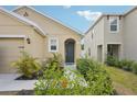 Home's welcoming front door with lush landscaping creating inviting curb appeal at 4012 Willow Hammock Dr, Palmetto, FL 34221
