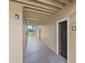 Hallway with door number 2017 leading to unit entrance, with stairs and view of trees and water at 4037 Crockers Lake Blvd # 17, Sarasota, FL 34238