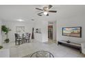 Open living room with neutral color scheme, tile floors, ceiling fan, with dining area at 4037 Crockers Lake Blvd # 17, Sarasota, FL 34238