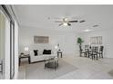 Inviting living room with natural light, tile flooring, ceiling fan, and a dining area at 4037 Crockers Lake Blvd # 17, Sarasota, FL 34238