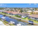 Aerial shot of a home with a screened-in lanai, canal access, a boat and small boats docked at its waterfront at 4312 Vasco St, Punta Gorda, FL 33950