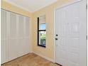 Bright entryway with a coat closet, a window and tile floors at 4471 Atwood Cay Cir # 13, Sarasota, FL 34233