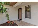 Inviting front entrance with textured walls and potted plants at 4471 Atwood Cay Cir # 13, Sarasota, FL 34233