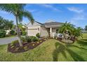 Beautifully landscaped front yard with palm trees enhancing the curb appeal of this lovely home at 4542 Cedar Brush Ter, Sarasota, FL 34243