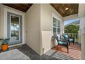 Inviting front porch featuring comfortable seating and a stylish front door, creating a warm welcome at 4542 Cedar Brush Ter, Sarasota, FL 34243