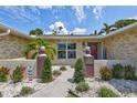 Inviting front entrance with decorative pineapple accents, manicured landscaping, and charming curb appeal at 5126 15Th W Ave, Bradenton, FL 34209