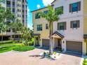 Attractive townhouse with manicured landscaping, brick driveway, and palm trees in a desirable community at 5561 Cannes Cir # 5101, Sarasota, FL 34231