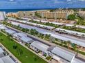 Scenic aerial shot of villas near the ocean with beachfront access and neatly arranged parking areas at 5858 Midnight Pass Rd # 27, Sarasota, FL 34242