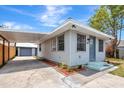 Home exterior featuring a covered carport, garden bed, and well-maintained curb appeal at 609 25Th W Ave, Bradenton, FL 34205