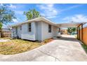 This is a view of the side yard, covered parking, and backyard fence of this home at 609 25Th W Ave, Bradenton, FL 34205
