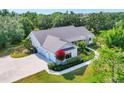 Beautiful aerial view of a single-story house showing the roof, landscaping, and driveway at 6102 9Th Avenue Cir Ne, Bradenton, FL 34212