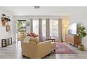 Bright living room with neutral tones, large windows, and stylish furnishings at 6442 Colonial Dr, Sarasota, FL 34231
