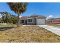 Charming single-story home with attached garage and a palm tree in the front yard at 6503 32Nd W Ave, Bradenton, FL 34209