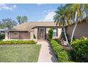 Charming home with a welcoming front entrance and beautiful landscaping at 6675 Easton Dr, Sarasota, FL 34238