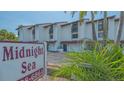 Image displays the community entrance for Midnight Sea residences, showcasing tropical landscaping and a coastal vibe at 6836 Midnight Pass Rd # 6836, Sarasota, FL 34242