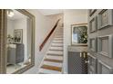 Inviting entryway features a staircase, stylish decor, and a large mirror to enhance the home's appeal at 6836 Midnight Pass Rd # 6836, Sarasota, FL 34242