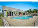 Backyard oasis features a sparkling pool, brick patio, and a privacy fence at 6909 34Th W Ave, Bradenton, FL 34209